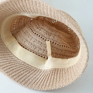 Detail of hollow woven sun hat inner lining with adjustable drawstring and sweatband