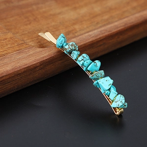 Macro detail of natural turquoise stones embedded in a golden metal hair clip