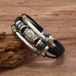 Vintage Viking leather bracelet for men with stainless steel compass charm on wood