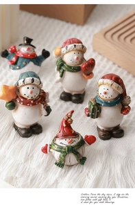Set of five resin Christmas snowman figurines with colorful scarves in festive setting
