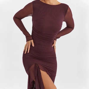 Detail of burgundy mesh dress featuring horizontal pleats and high slit hemline