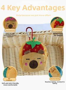Detail of Capybara plush bag with strawberry hat, soft PP cotton and red metal carabiner