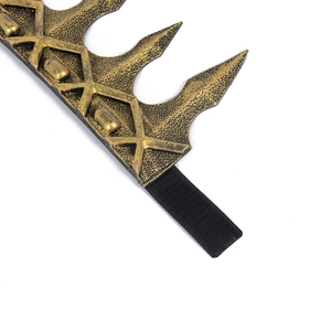 Macro detail of bronze gold medieval crown showing vintage texture and elastic band