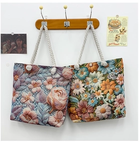 Detail of floral embroidery on canvas tote bags with rustic hemp rope handles