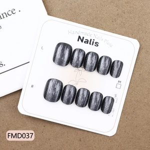 Short obsidian cat-eye press-on nails with silver shimmer on white display board