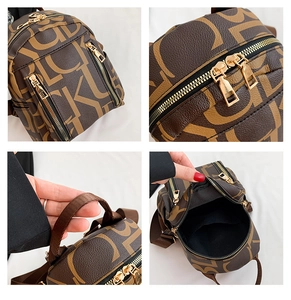 Detail view of brown PU leather backpack featuring letter patterns and gold hardware