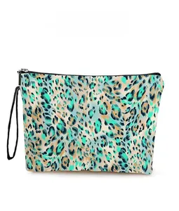 Detail of green leopard print cosmetic bag showing durable zipper and sturdy handle strap