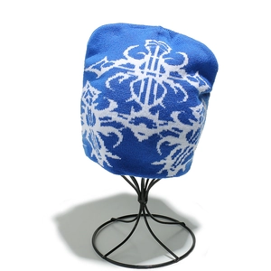 Dettaglio di un berretto in maglia blu e bianco con motivo jacquard tribal su base