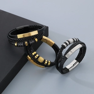 Detailed shot of multi-layer braided leather bracelets with Greek key pattern magnetic clasp