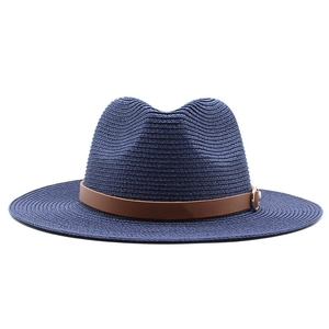 Close-up of dark blue woven Panama hat with brown leather band and silver buckle