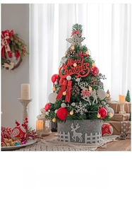 Detail of a 60cm mini Christmas tree with red berries, white snowflakes, and felt deer base