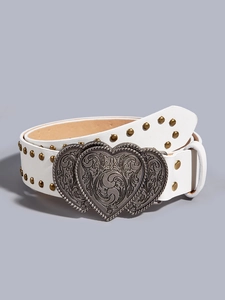Close-up of white punk belt featuring double heart vintage metal buckle and gold studs