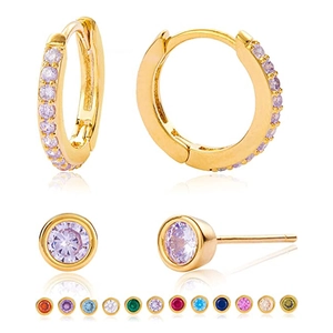 Macro shot of 925 sterling silver hoop earrings and studs set with colorful gemstones