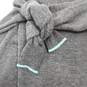 Gray knitted off-shoulder sweater with mint blue contrast trim and knotted detail