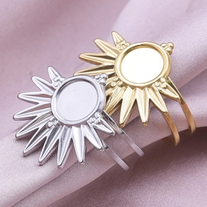Detail showing gold and silver sunburst rings on purple silk fabric for jewelry DIY