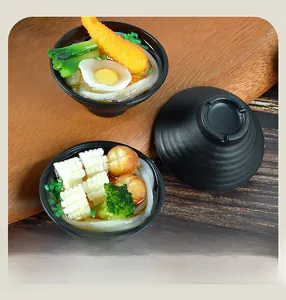 Macro view of realistic Japanese udon noodle model with egg and tempura toppings