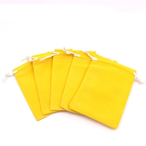 Five yellow mini fabric jewelry pouches with drawstring closure on white background