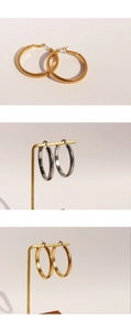 Macro detail of hoop earrings with textured spiral design in gold and silver metal finishes