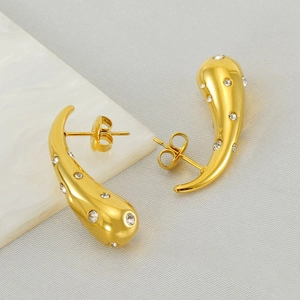Water drop 18K gold stainless steel earrings with sparkling diamonds on marble background