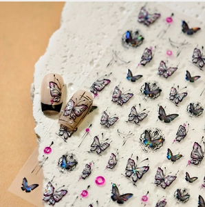 Macro shot of 3D embossed butterfly nail art stickers with laser finish and shell texture
