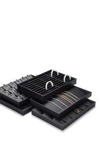 Detailed set of black PU leather jewelry display trays for rings and necklaces