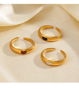 Three 18K gold plated heart rings with red black and white stones on silk fabric