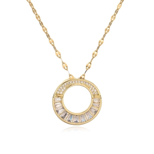 Close-up of gold-plated pendant with sparkling cubic zirconia on white background