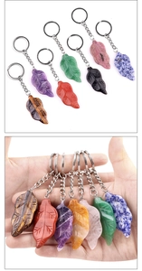 Detailed view of leaf-shaped natural stone keychains in seven various colors and textures