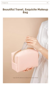 Detail of pink PU leather makeup bag with gold zipper held by model for travel size