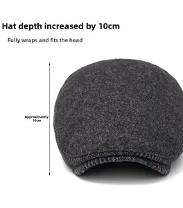 Detail view of a dark grey wool flat cap showing the 10cm depth and warm texture