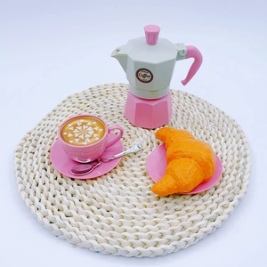 Detailed play set with pink mocha pot, latte with art, and plastic toy croissant