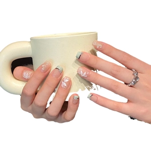 Handmade press-on nails with mint green floral art and pearl accents for bridal look