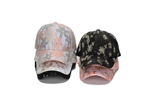 Detail view of four lace baseball caps with floral embroidery in pink, black and white