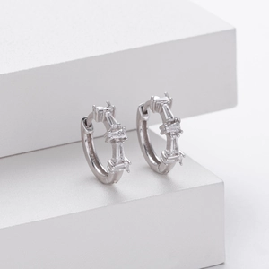 Macro detail of S925 sterling silver earrings with inlaid baguette-cut zircon stones
