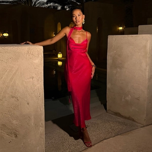 Elegant red satin slip dress with cowl neck and matching scarf in a luxury resort setting