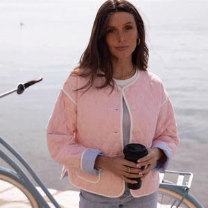 Quilted pink crewneck jacket with white contrast piping and striped lining details