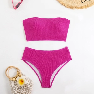 Detail of rose pink crinkle fabric on a two-piece bikini set with high-waist bottoms