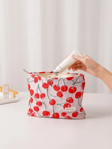 Pink canvas cosmetic bag with red cherry prints and H&R BAG label for skin care storage