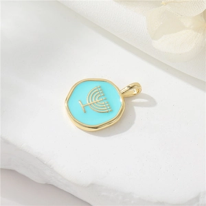 Macro view of a 14K gold-plated Menorah pendant with light blue enamel on stone