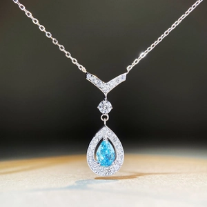 Macro shot of S925 silver necklace with teardrop blue stone and zircon accents