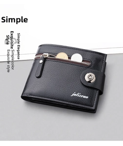Macro detail of black leather wallet showing litchi texture and front zipper pocket