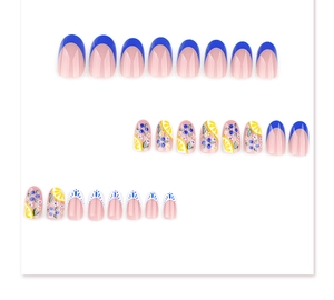 Macro shot of French blue almond press-on nails with hand-painted lemon and berry designs