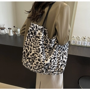 Detail of the black and white leopard print quilted tote bag with a black shoulder strap