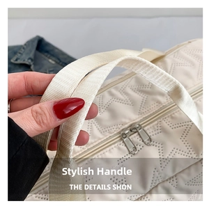 Close-up of cream fitness bag featuring star-quilted texture and sturdy woven handles