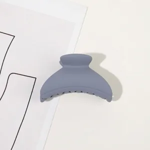 Detail of matte Morandi blue shark hair clip with a minimalist crescent design