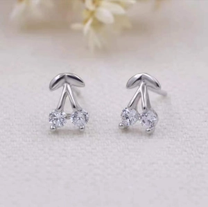 Minimalist silver cherry stud earrings featuring clear cubic zirconia and floral accents