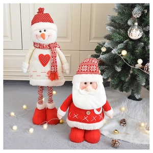 Close-up of knitted Santa and Snowman plush dolls with soft textures for Christmas decor