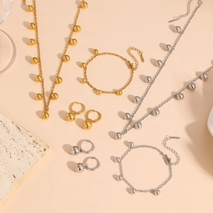 Detailed flat lay of gold and silver beaded jewelry sets with elegant fringe accents