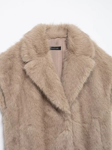 Detail shot of plush faux fur texture and large lapel collar on the brown vest