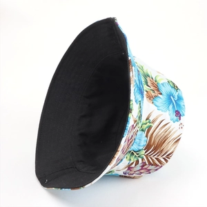 Reversible bucket hat with tropical floral print and black cotton canvas design